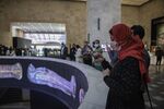 Visitors take photos of a screening about the royal mummies at the new National Museum of Egyptian Civilisation.&nbsp;Twenty-two&nbsp;mummies were transported through central Cairo to the museum last April.