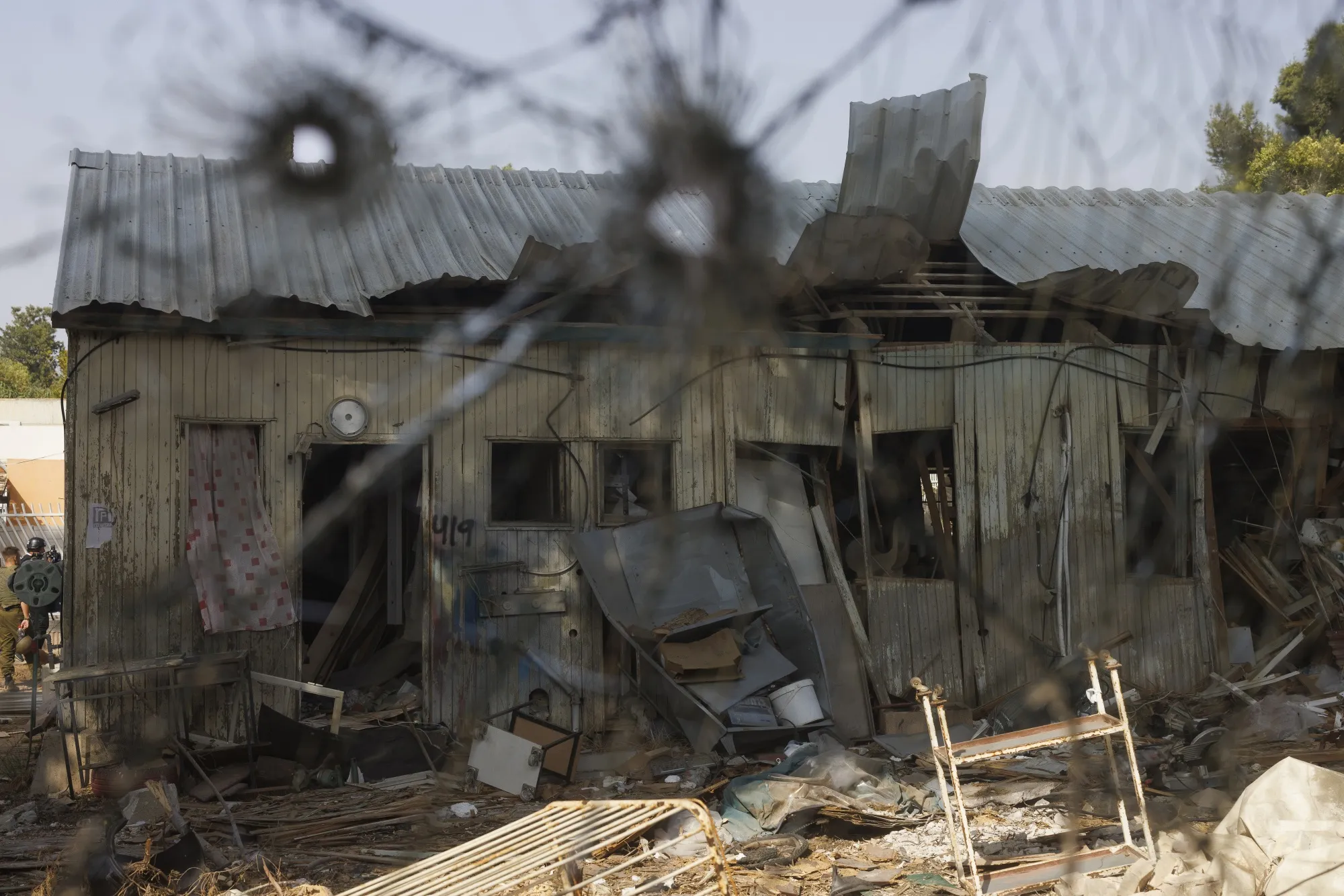 Bullet holes in the window of a home following an attack by Hamas militants in Kibbutz Be'eri, Israel, on Sunday.