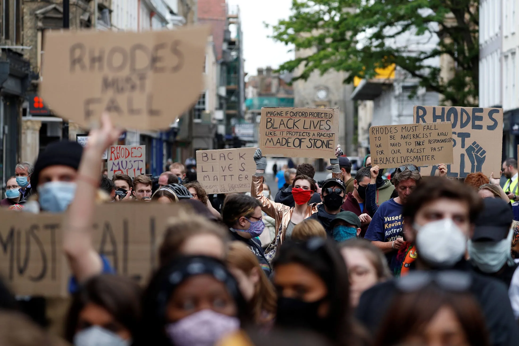 Protestors call for the removal of the statue of Cecil Rhodes outside Oriel College, at the University of Oxford on June 9.&nbsp;