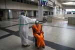 A medical worker collects a swab sample from a passenger for a RT-PCR test in New Delhi on Thursday.