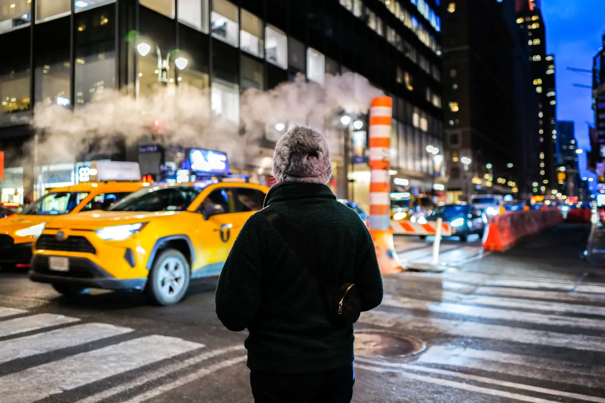 A pedestrian waits to cross Lexington Avenue in Manhattan in February 2024.&nbsp;