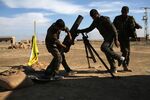 Troops from the Syrian Democratic Forces prepare to fire mortars near Hasaka, in the autonomous region of Rojava, Syria, on Nov. 11, 2015.
