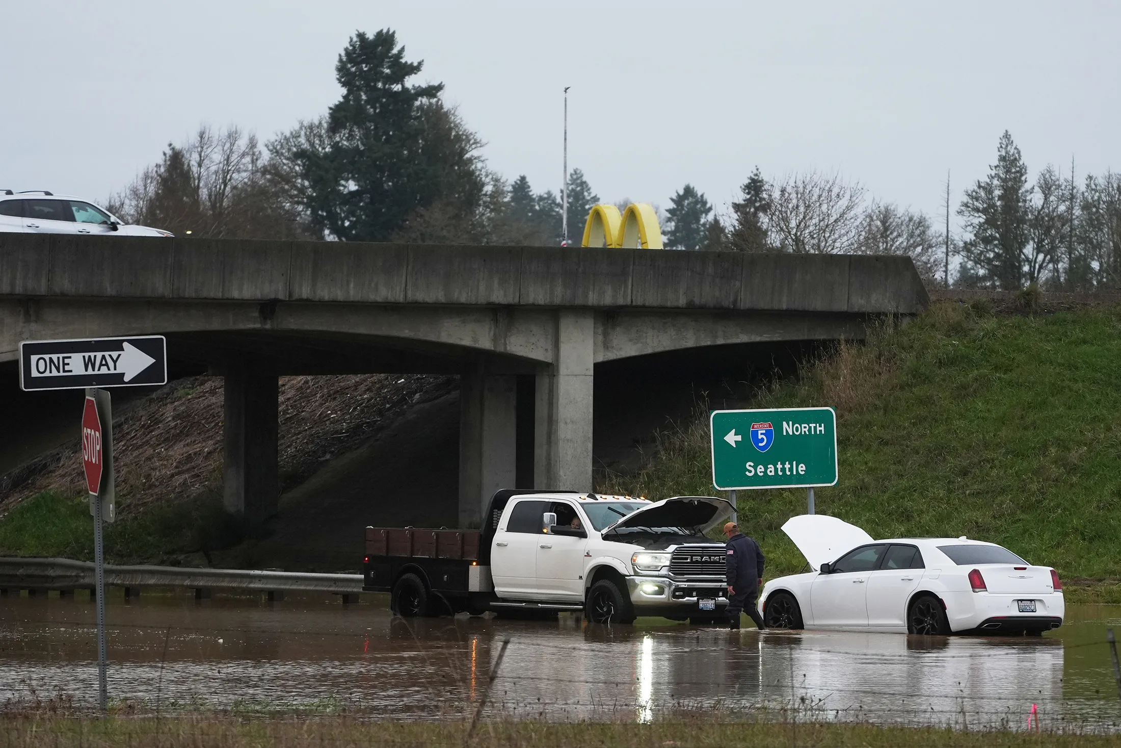 A man checks on a car caught in flooding after heavy rains&nbsp;in Napavine, Washington, on Dec. 9.