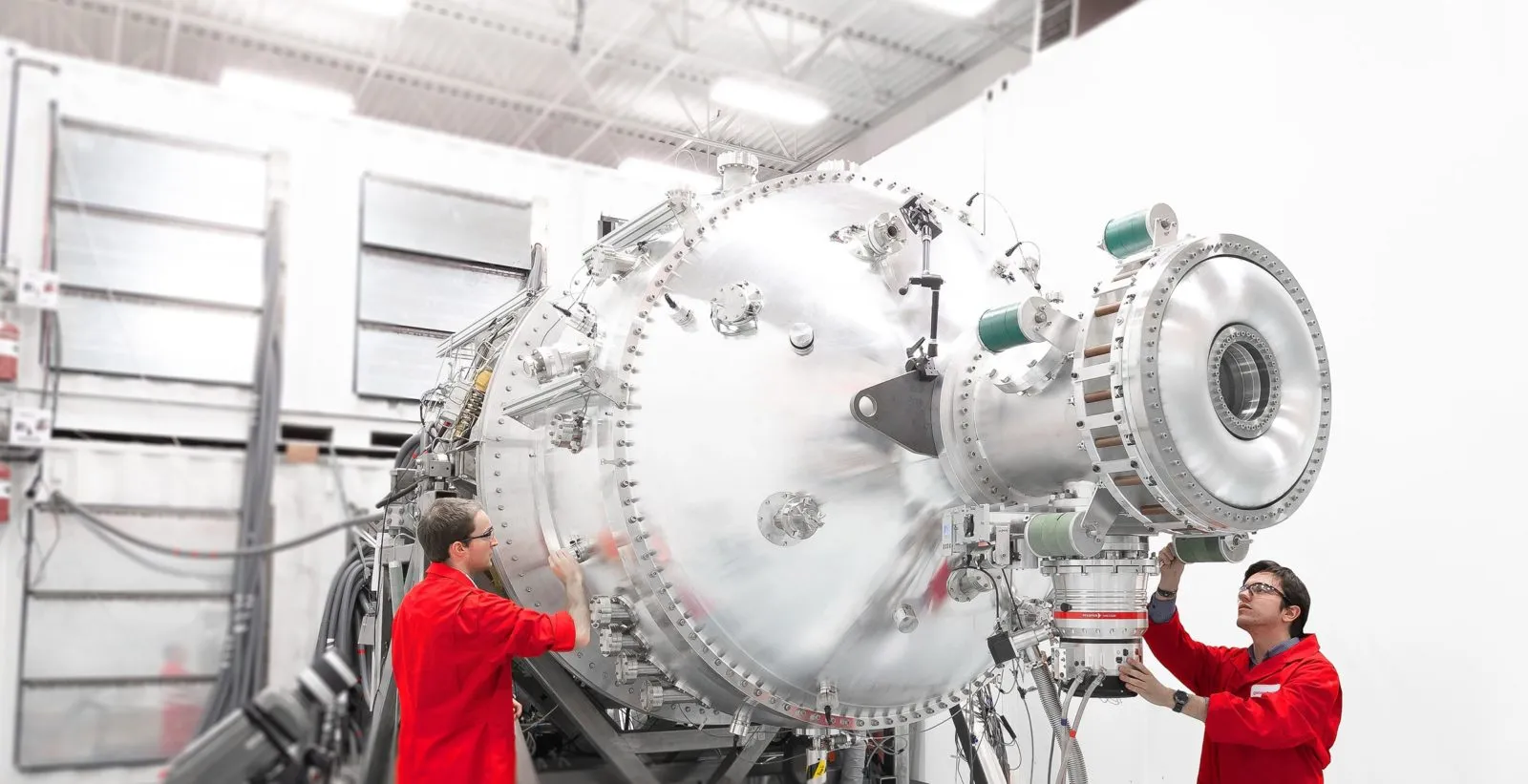 Workers inspect the PI3 Plasma Injector at General Fusion.