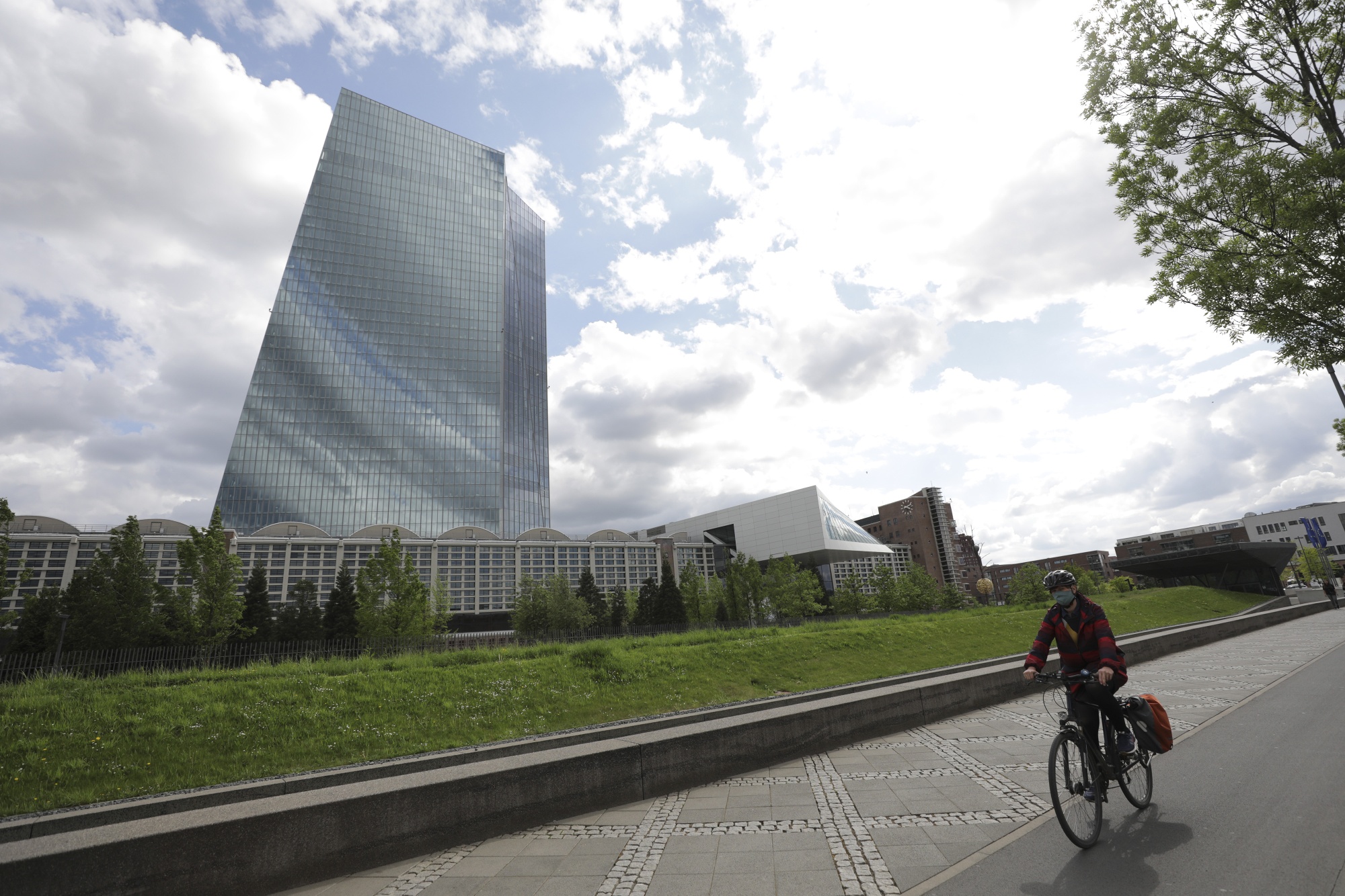 A cyclist passes the European Central Bank headquarters in Frankfurt.