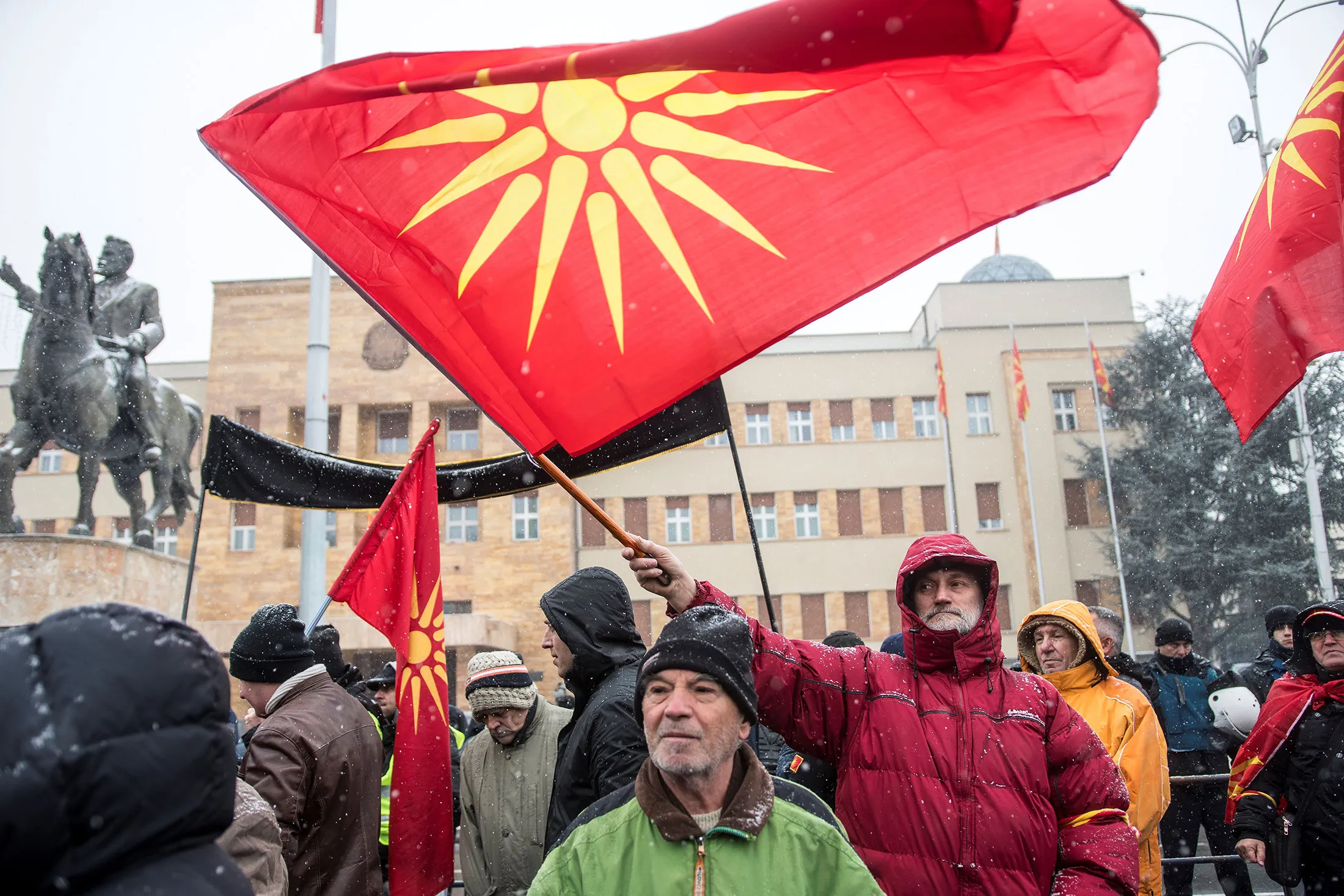 Demonstrators wave an old Macedonian flag during a protest against a process of renaming the country's name in front of the Parliament building in Skopje on Jan. 9.