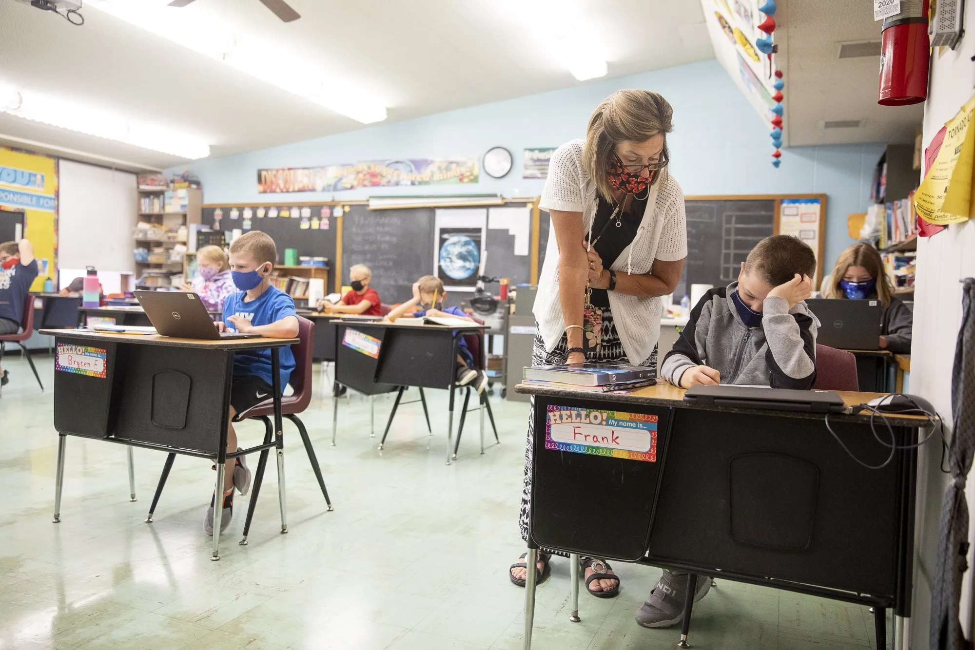 A teacher assists a student at Logan Jr. High School in Princeton, Illinois.