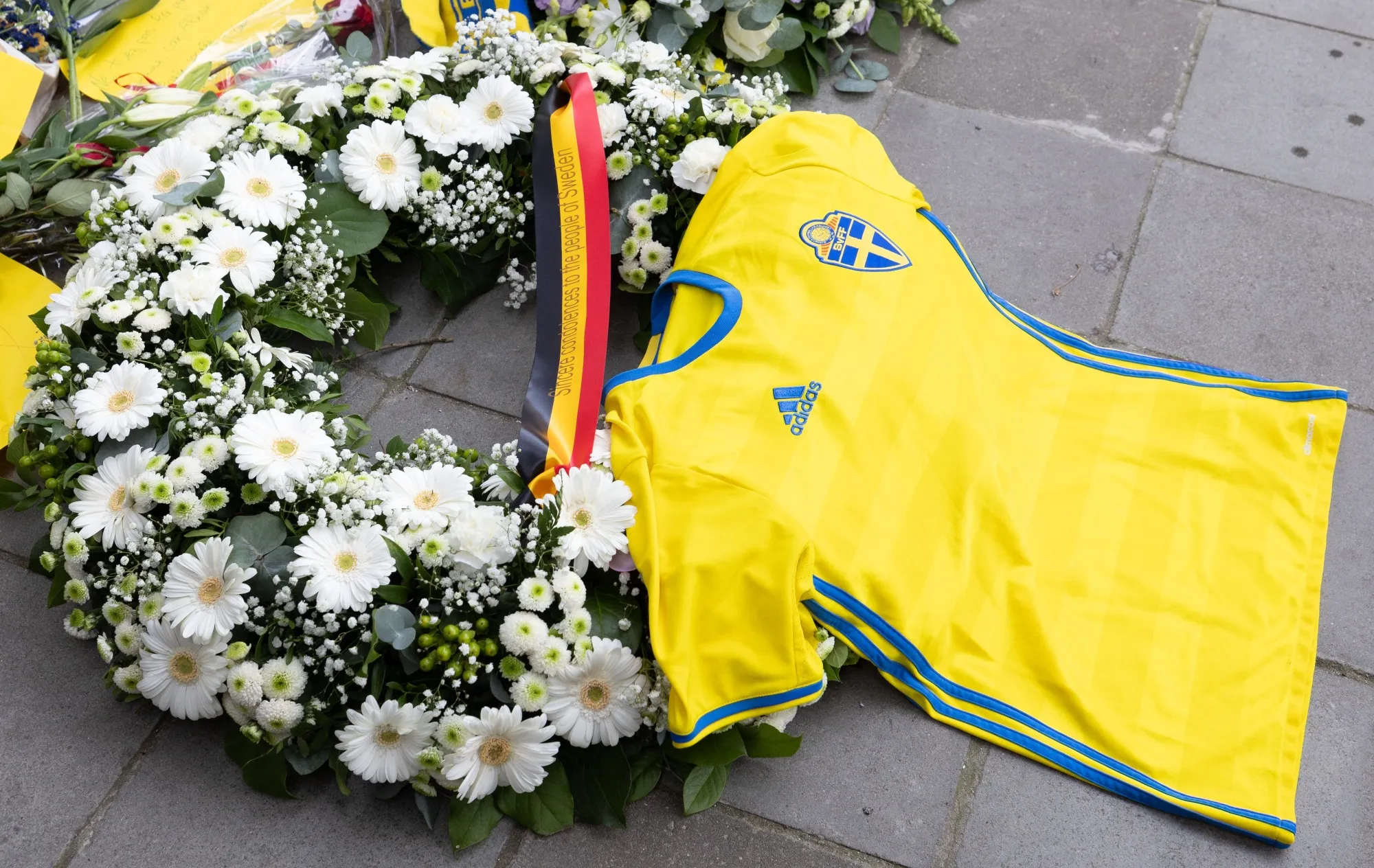 Flowers and a shirt of the Swedish national soccer team at a commemoration for the victims in Brussels on Oct. 18.