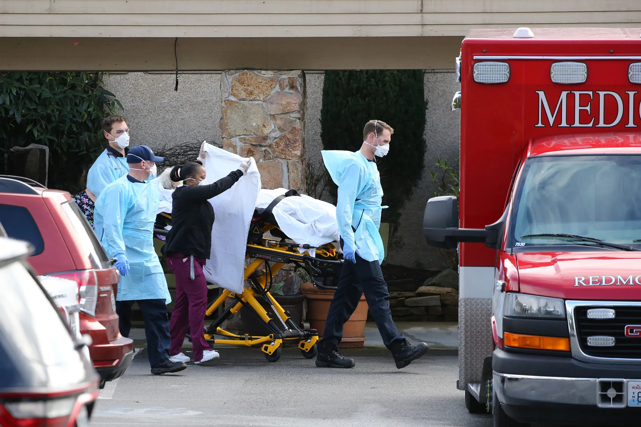 A patient is transferred into an ambulance at the Life Care Center in Kirkland, Washington, on Saturday.
