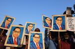 People hold portraits of Babasaheb Ambedkar during a protest in Kolkata, India.&nbsp;