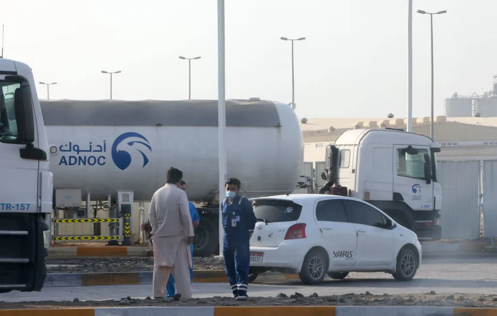 Men stand outside an&nbsp;ADNOC oil storage unit in Abu Dhabi.