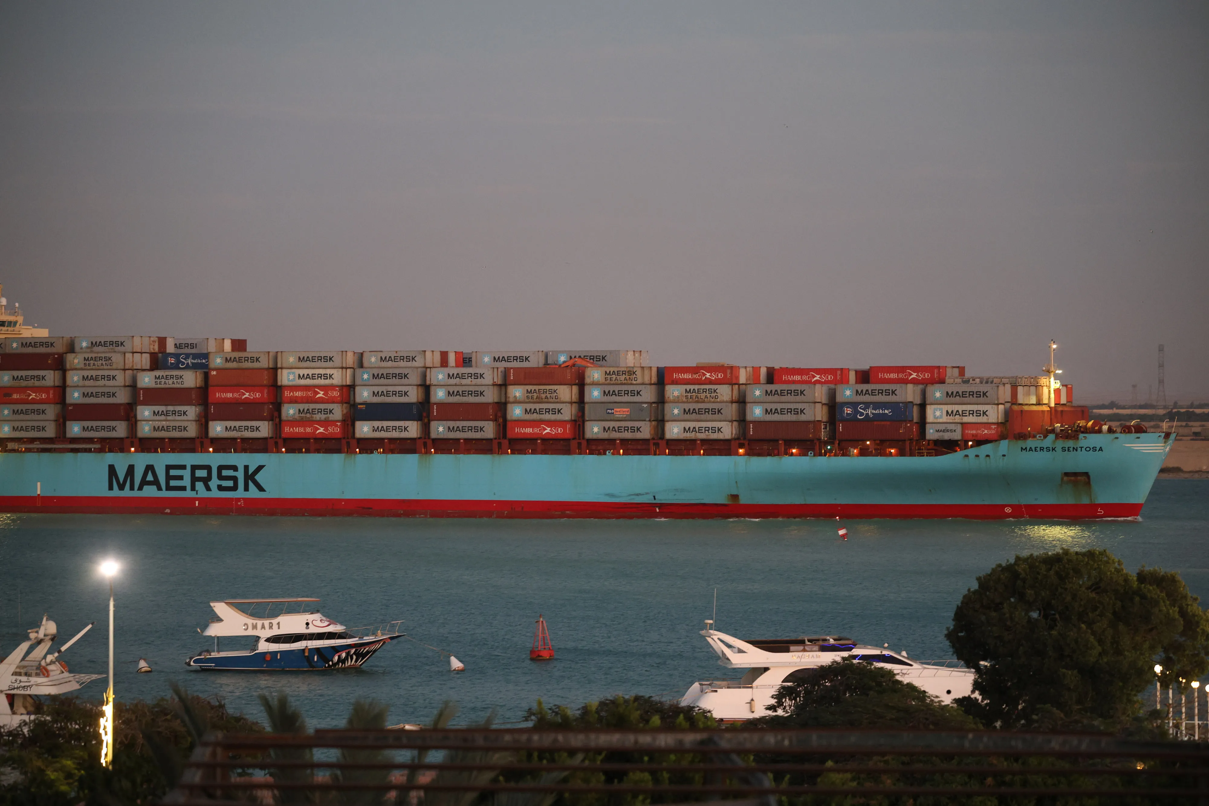 A container ship sails southbound to exit the Suez Canal in 2023. A return of container traffic to the Red Sea is one of many changes to global trade coming in the new year.&nbsp;