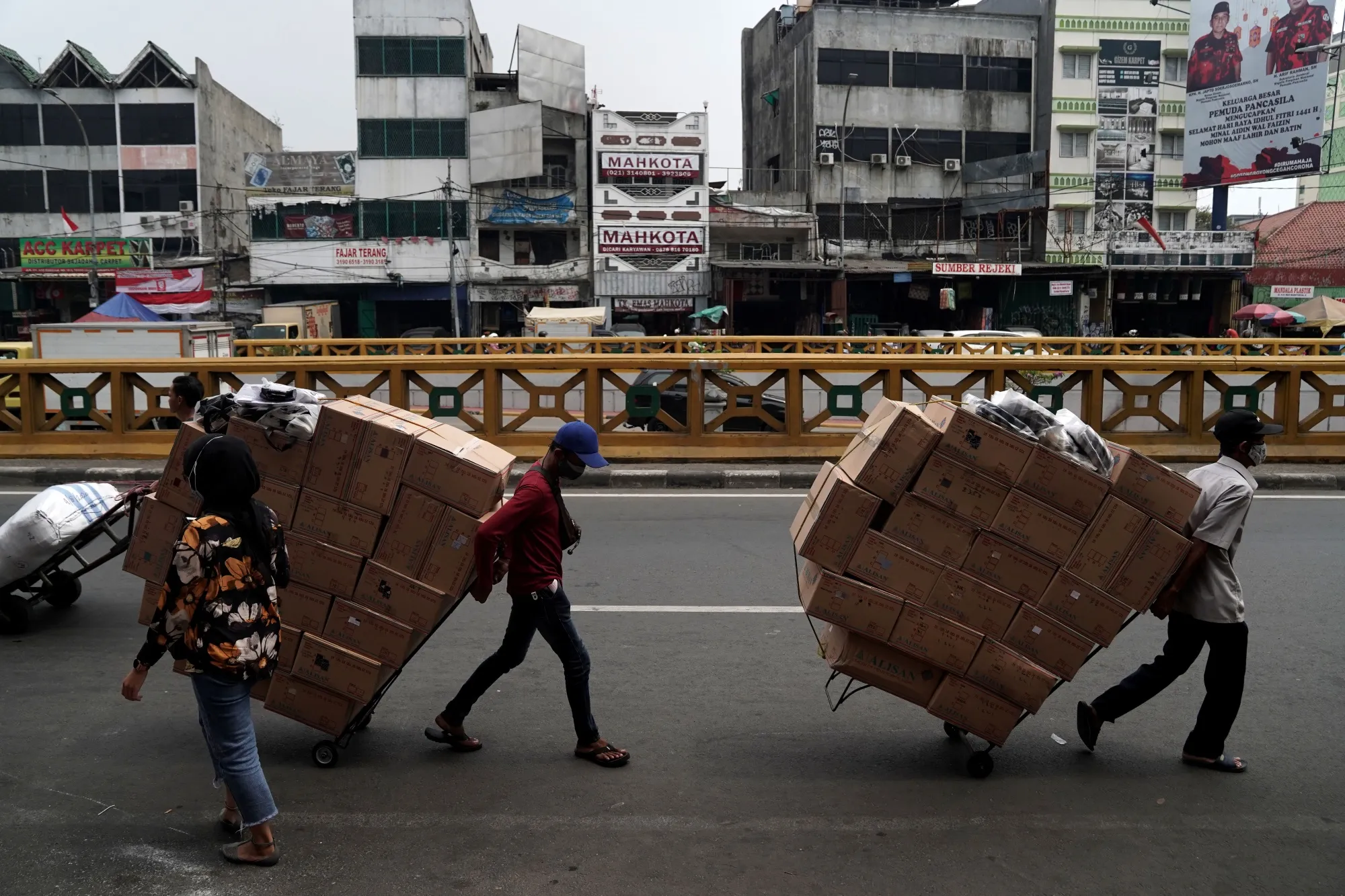 Workers transport carts at&nbsp;Tanah Abang market in Jakarta, Indonesia.
