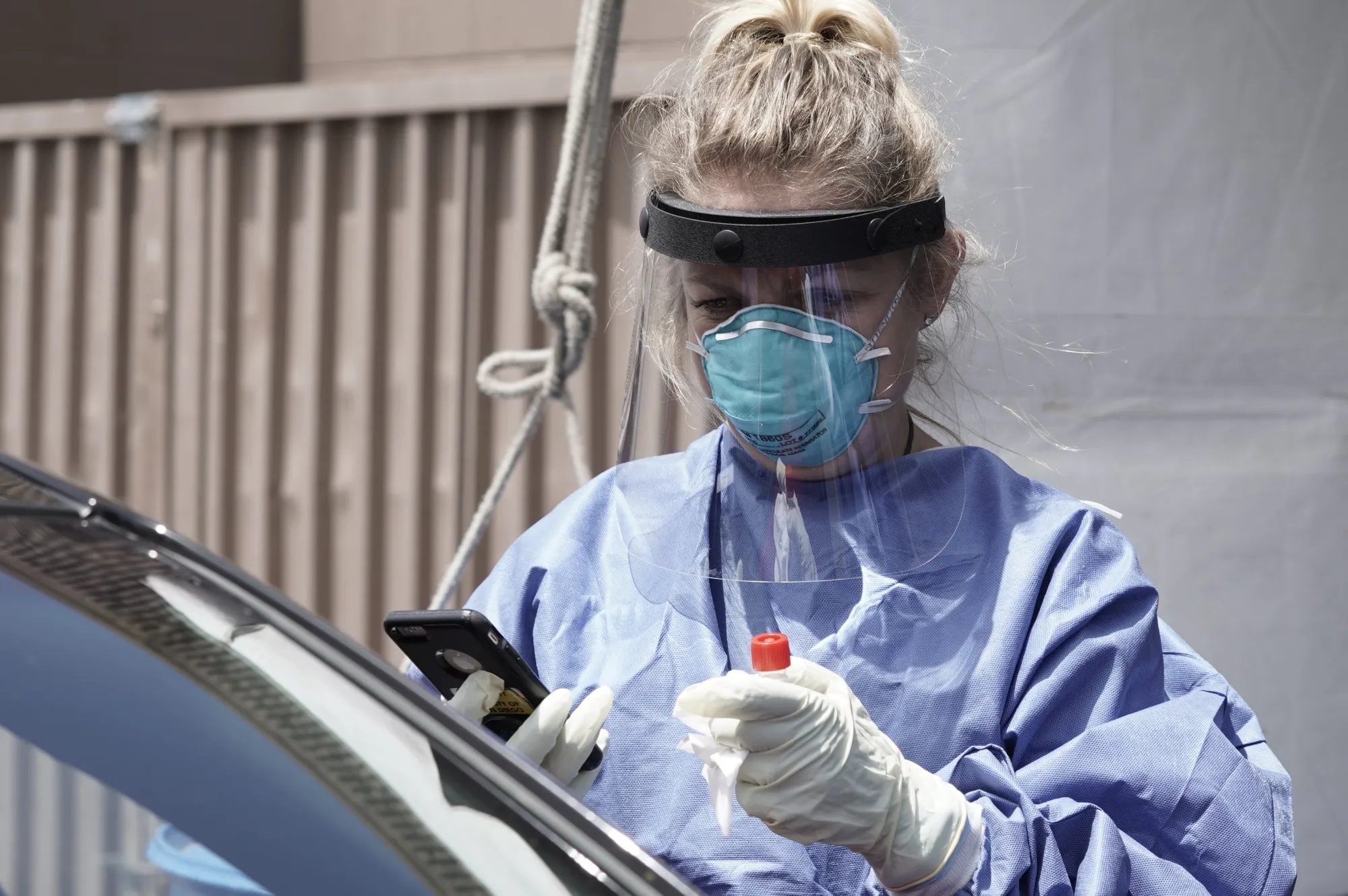 A nurse speaks with a patient at a Covid-19 drive-through testing site&nbsp;in Escondido, California.