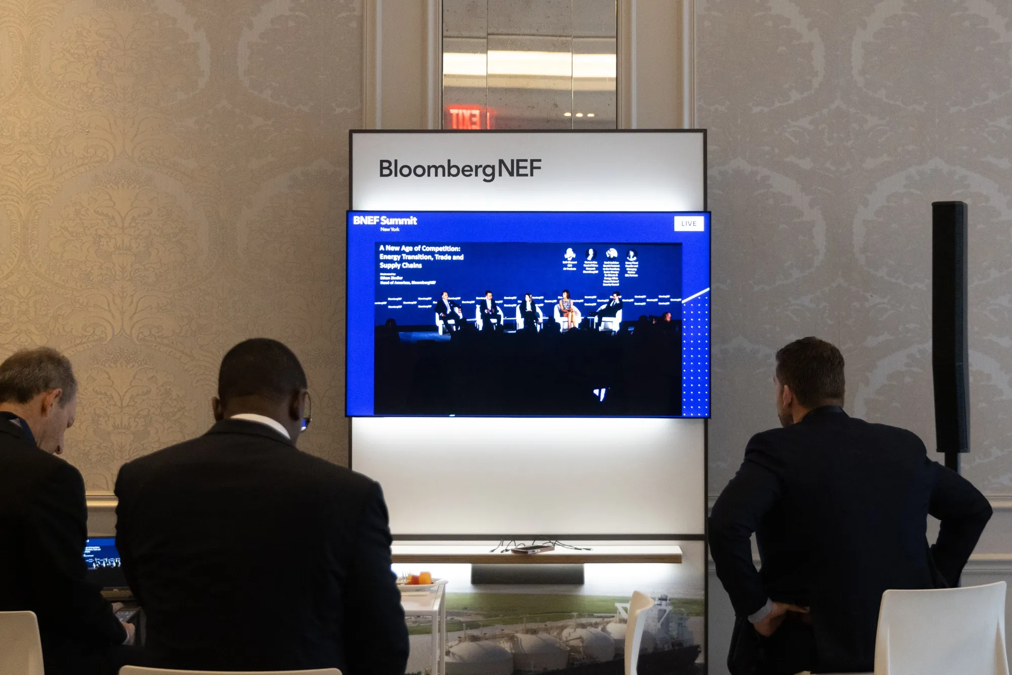 Attendees watch a live stream during the BNEF summit in New York.