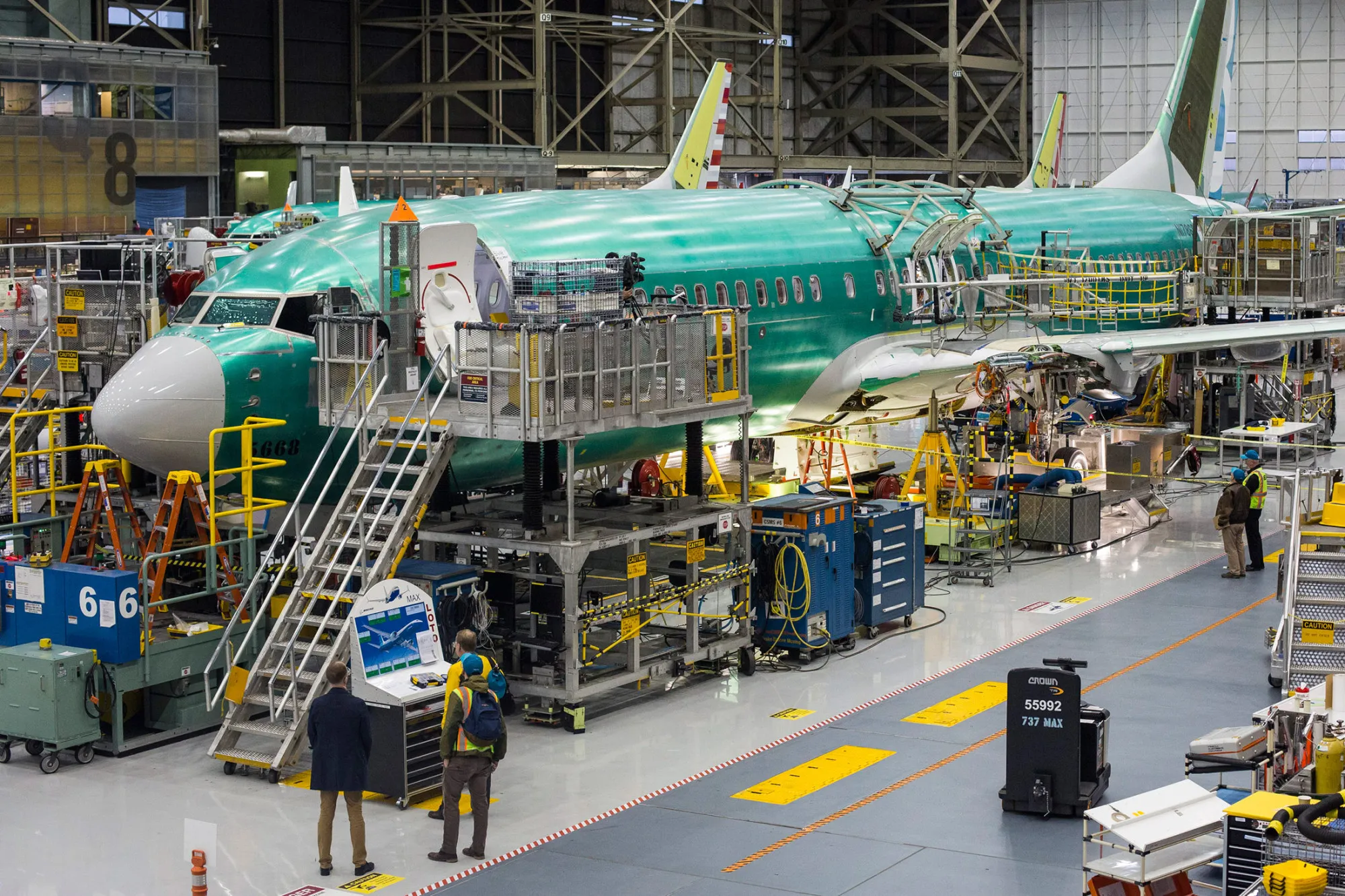 Employees work on a Boeing 737 MAX airplane at the Boeing manufacturing facility in Renton, Washington.
