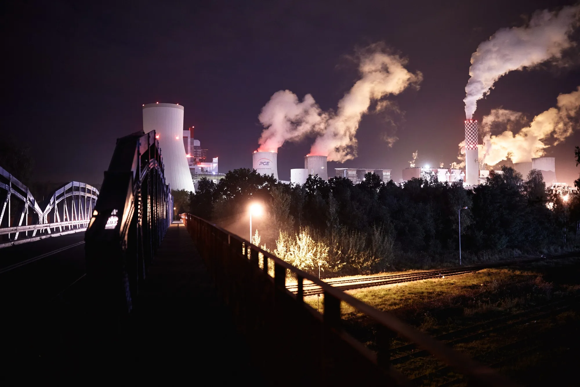 Emissions rise from chimneys at the Turow coal powered power plant, operated by PGE SA, at night in Bogatynia, Poland, on Tuesday, Sept. 29, 2020. Poland may finally be on the path to set the end-date for its unprofitable coal industry as an agreement with mining unions is within sight.