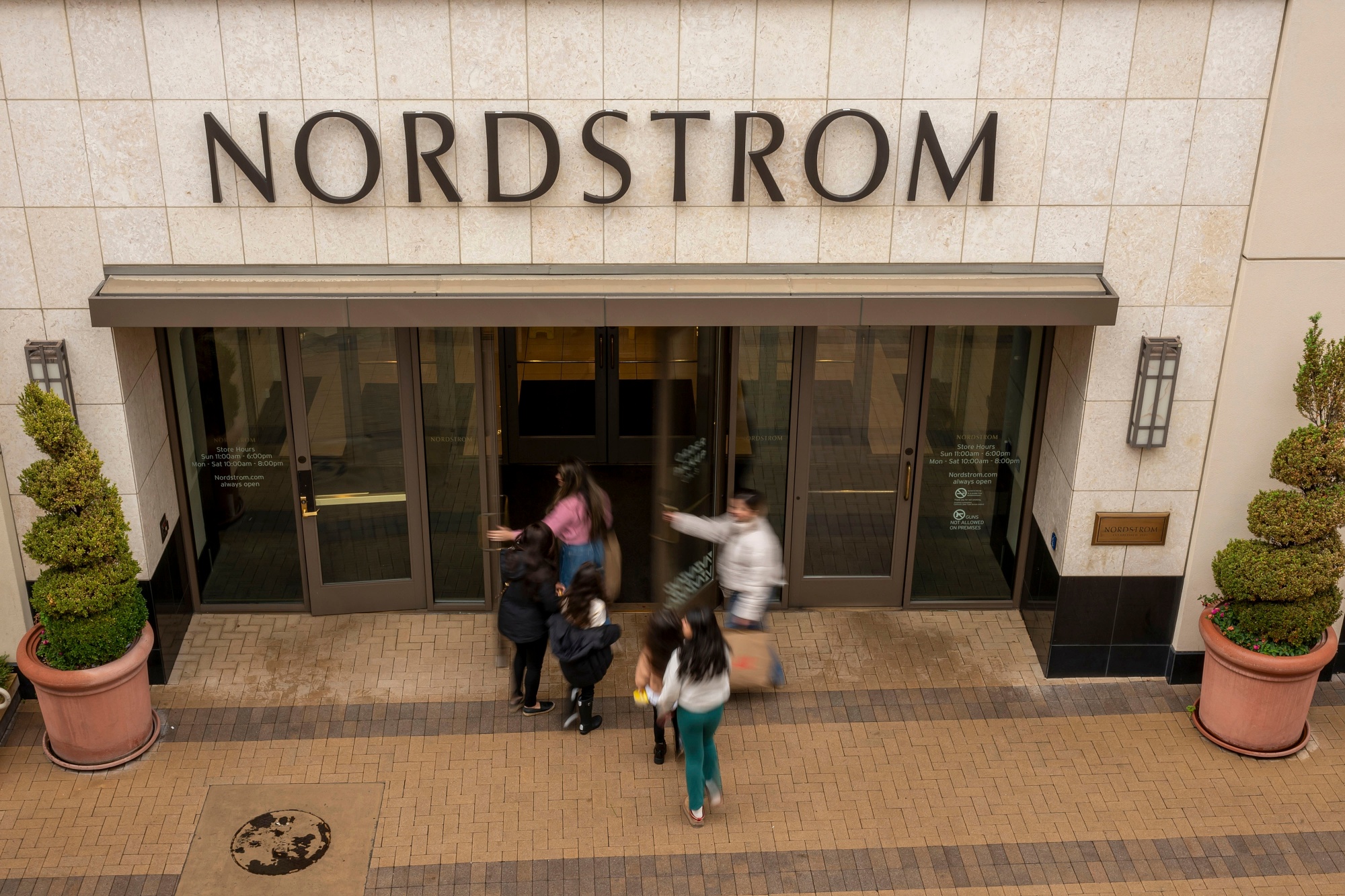 Shoppers enter a Nordstrom store in Walnut Creek, California. Photographer: David Paul Morris/Bloomberg