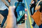 HONG KONG, HONG KONG SAR, CHINA - 2013/07/30: The Apple Store's logo is reflected in the touch screen of an iPhone in Hong Kong.