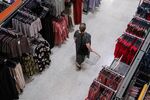 A shopper walks down the clothing aisle inside a&nbsp;supermarket in London.