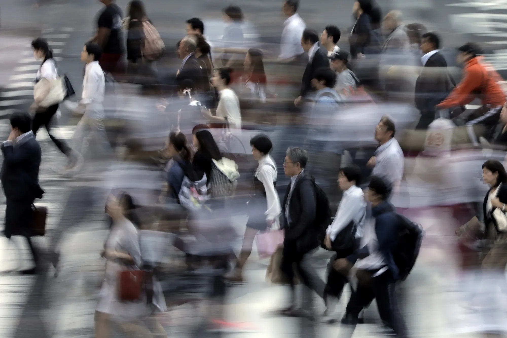 Pedestrians cross a road in Tokyo, Japan.