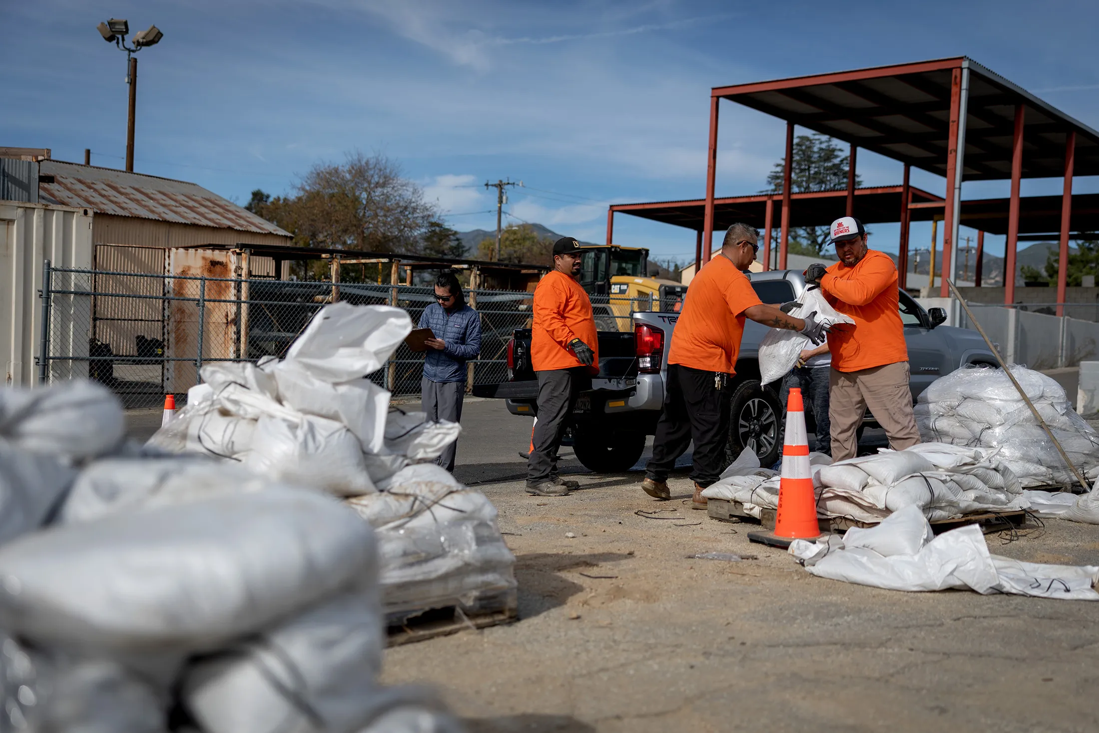 Los Angeles County Public Works Department workers distribute sandbags to residents at a county works public yard in Altadena, California, on Dec. 22.