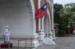 An honor guard stands next to the Taiwanese flag at the National Revolutionary Martyrs' Shrine in Taipei, Taiwan, on Tuesday, May 24, 2022. 