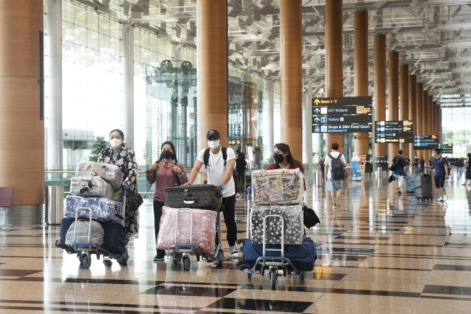 Travelers at Changi Airport in Singapore.