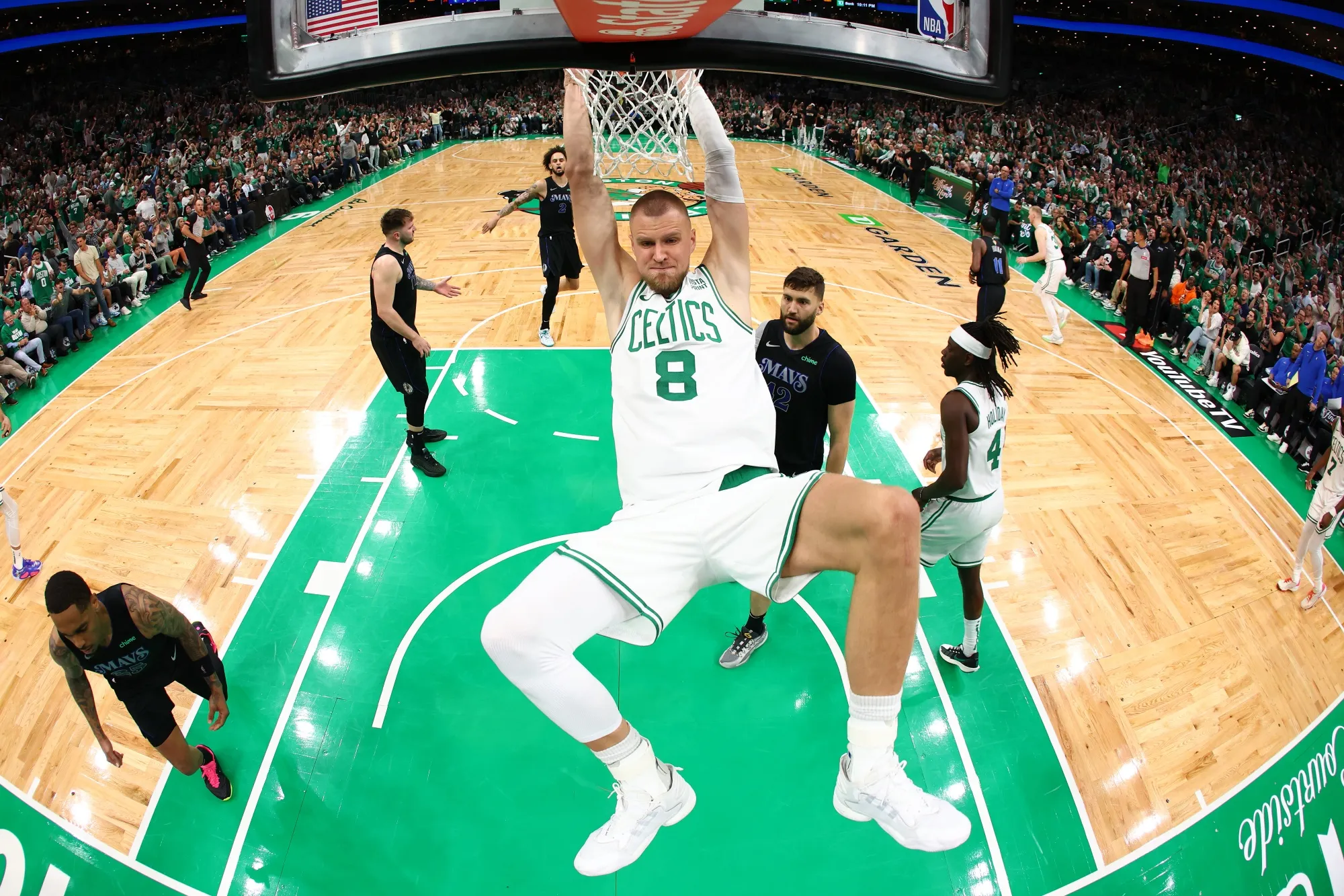 Kristaps Porzingis of the Boston Celtics dunks the ball against the Dallas Mavericks during the 2024 NBA Finals.