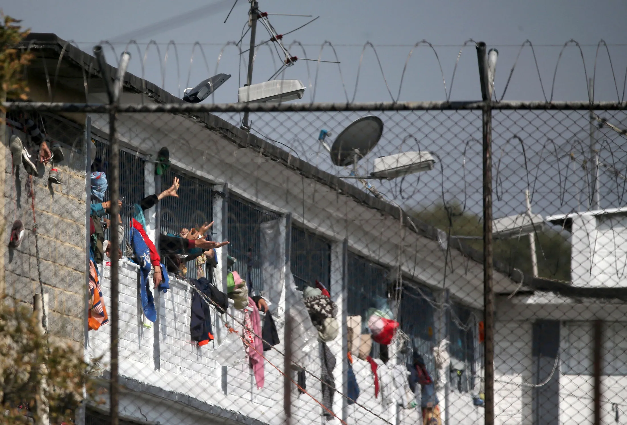 Inmates extend their hands out of windows after a riot at the Modelo prison in Bogota on March 22.