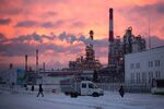 A red dawn illuminates cracking towers at the Lukoil-Nizhegorodnefteorgsintez oil refinery, operated by OAO Lukoil, in Nizhny Novgorod, Russia, on Thursday, Dec. 4, 2014.

