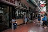People look through the window of a gun shop on Burapha Road in Bangkok, Thailand.