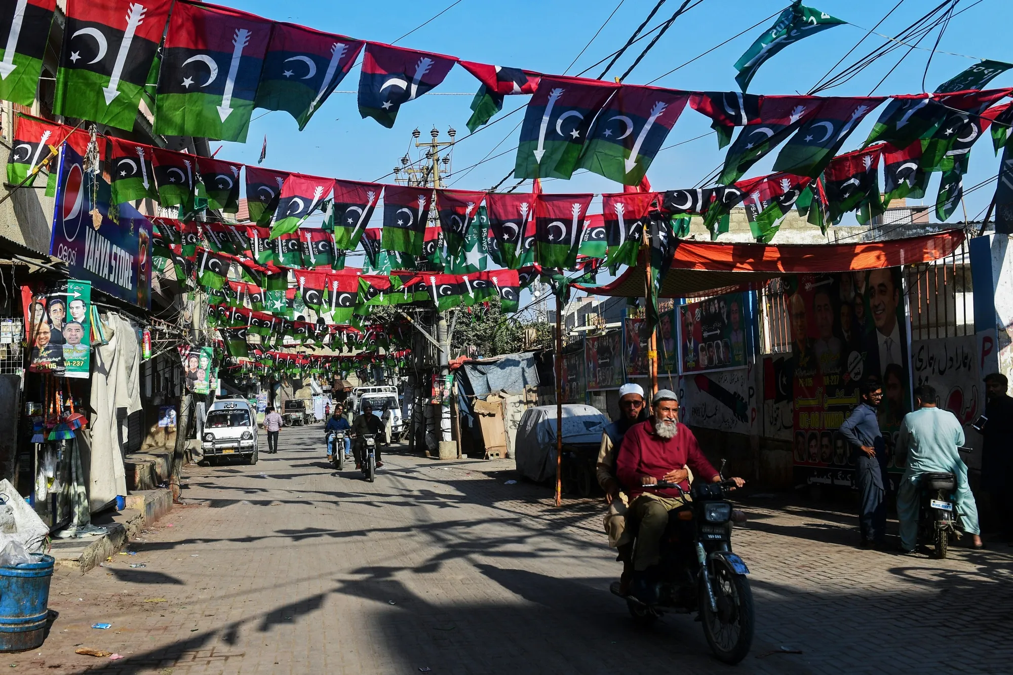 Election banners and posters hang over a street in Karachi on Jan. 29.