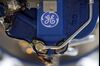 A GE logo sits on a H80 turboprop aircraft engine, produced by General Electric Co. (GE), as it stands on display at the company's chalet on the first day of the Farnborough International Airshow in Farnborough, U.K., on Monday, July 14, 2014. The Farnborough International Air Show, which runs July 14-20, is this year's biggest forum for aircraft introductions and sales.