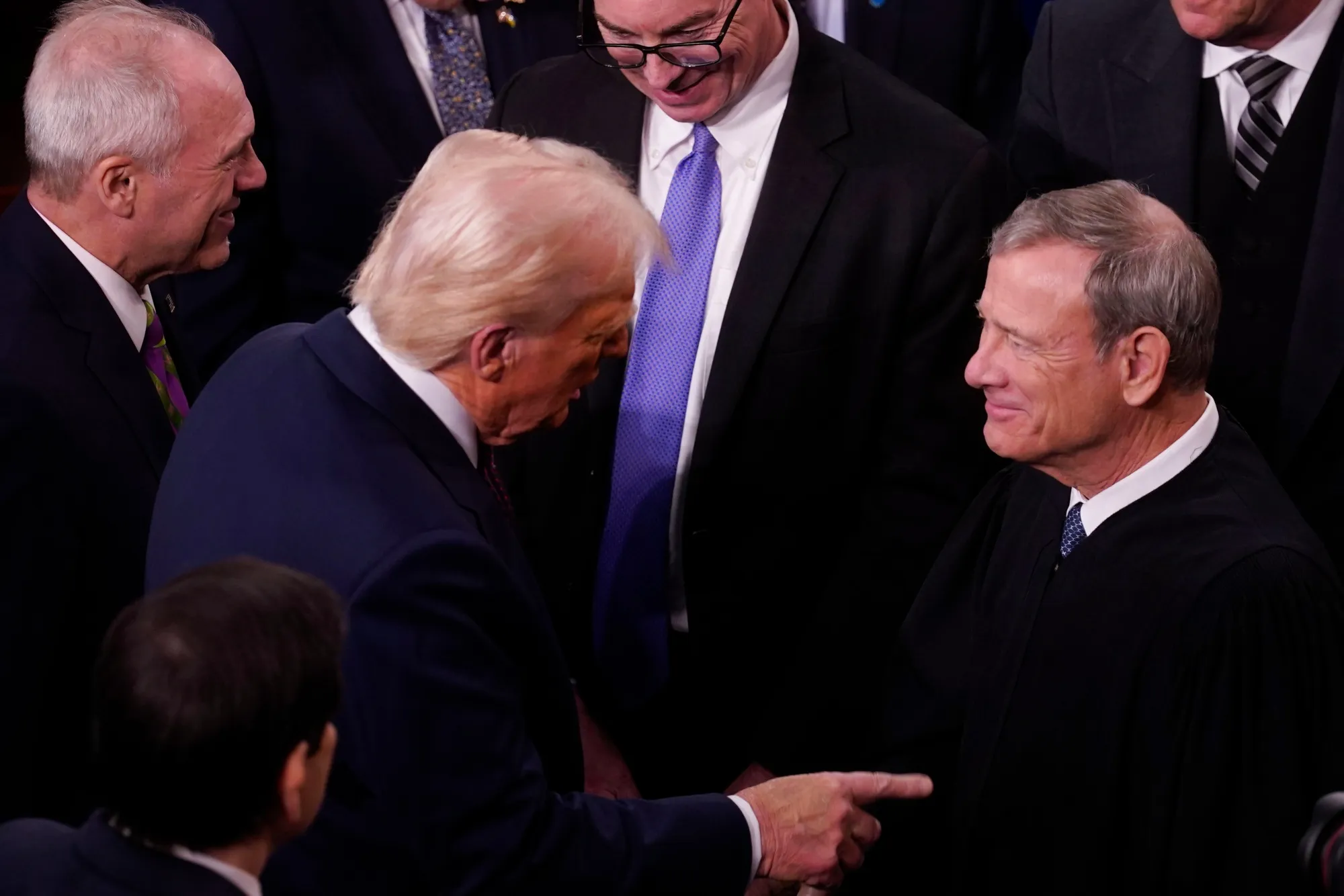 US President Donald Trump, left, greets John Roberts, chief justice of the US Supreme Court, at a joint session of Congress on March 4.