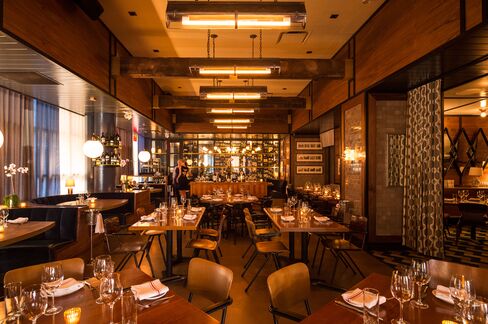 The Bowery Meat Company's chic, midcentury modern dining room.