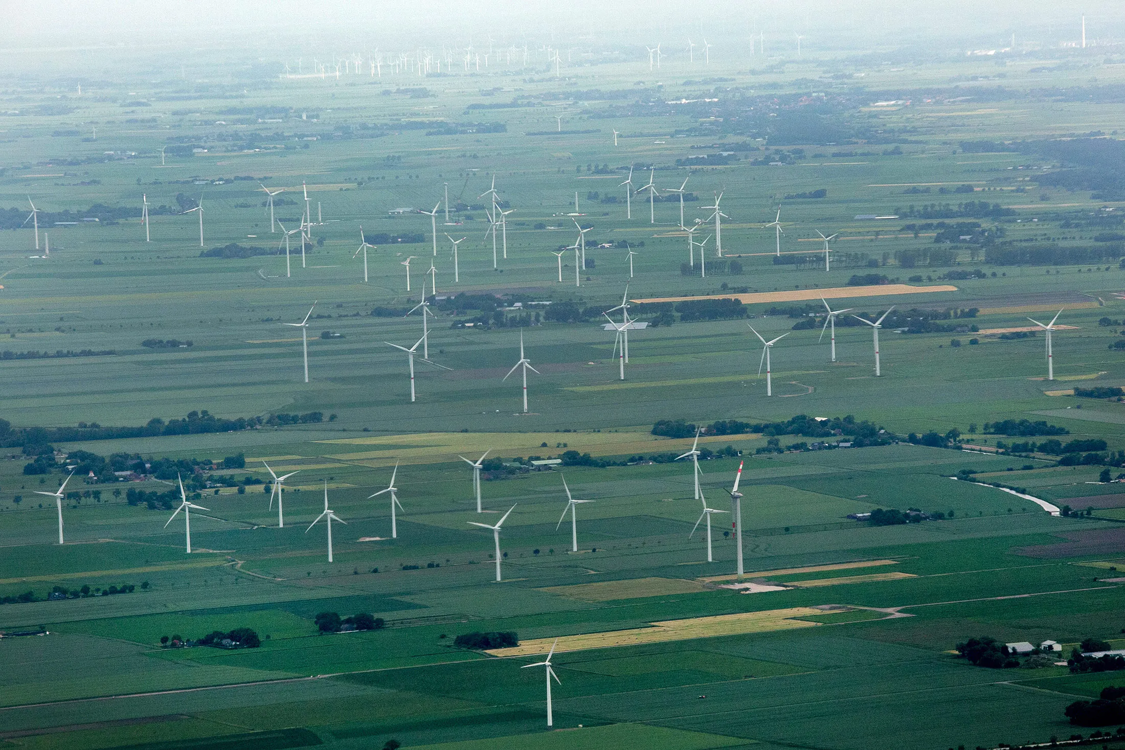 Wind turbines operate on an onshore green field site in this aerial photograph taken near Hamburg.
