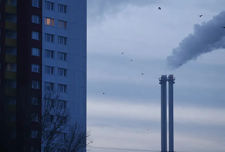 Exhaust rises from a chimney.