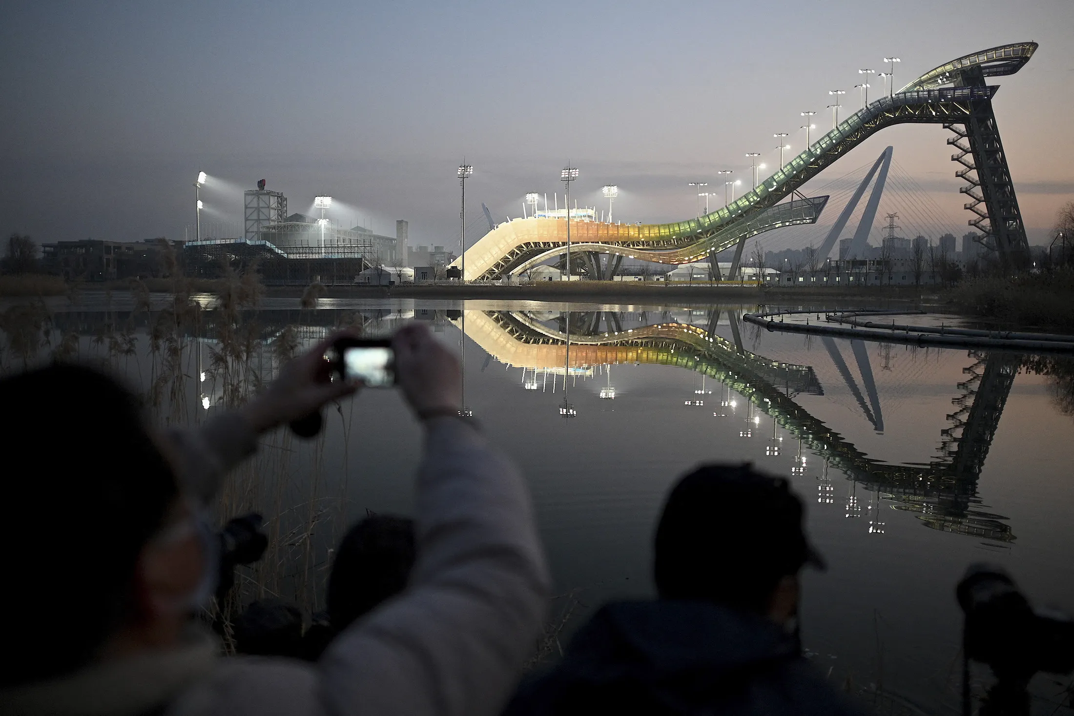 Visitors take photos of the Shougang Big Air venue ahead of the&nbsp;Beijing 2022 Winter Olympics.