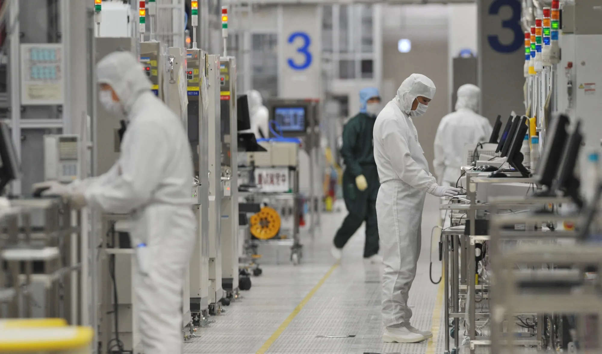 Employees work at a wafer fabrication factory in Hitachinaka, Ibaraki prefecture, Japan.
