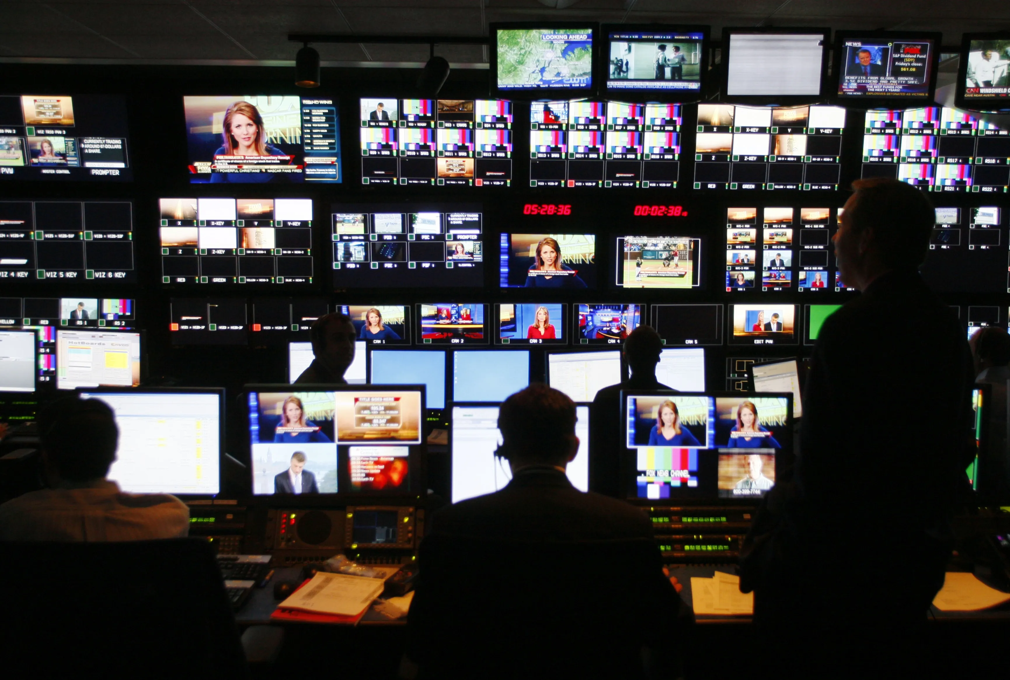Technicians watch over television monitors and computer screens.