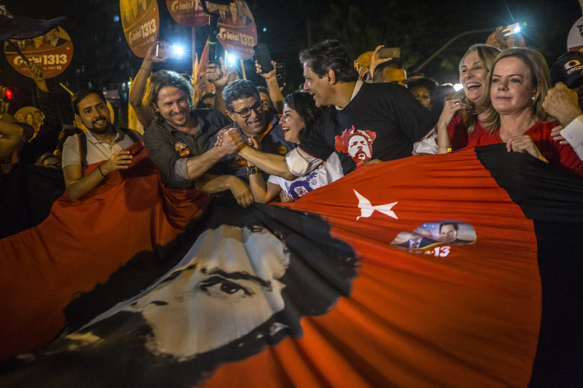 Fernando Haddad, former mayor of Sao Paulo, third right, and Senator Gleisi Hoffman, president of the Workers' Party (PT), right, join demonstrators during a rally against local government officials and in support of jailed former president&nbsp;Luiz Inacio Lula da Silva&nbsp;in Curitiba, Brazil, on&nbsp;Aug. 30.&nbsp;