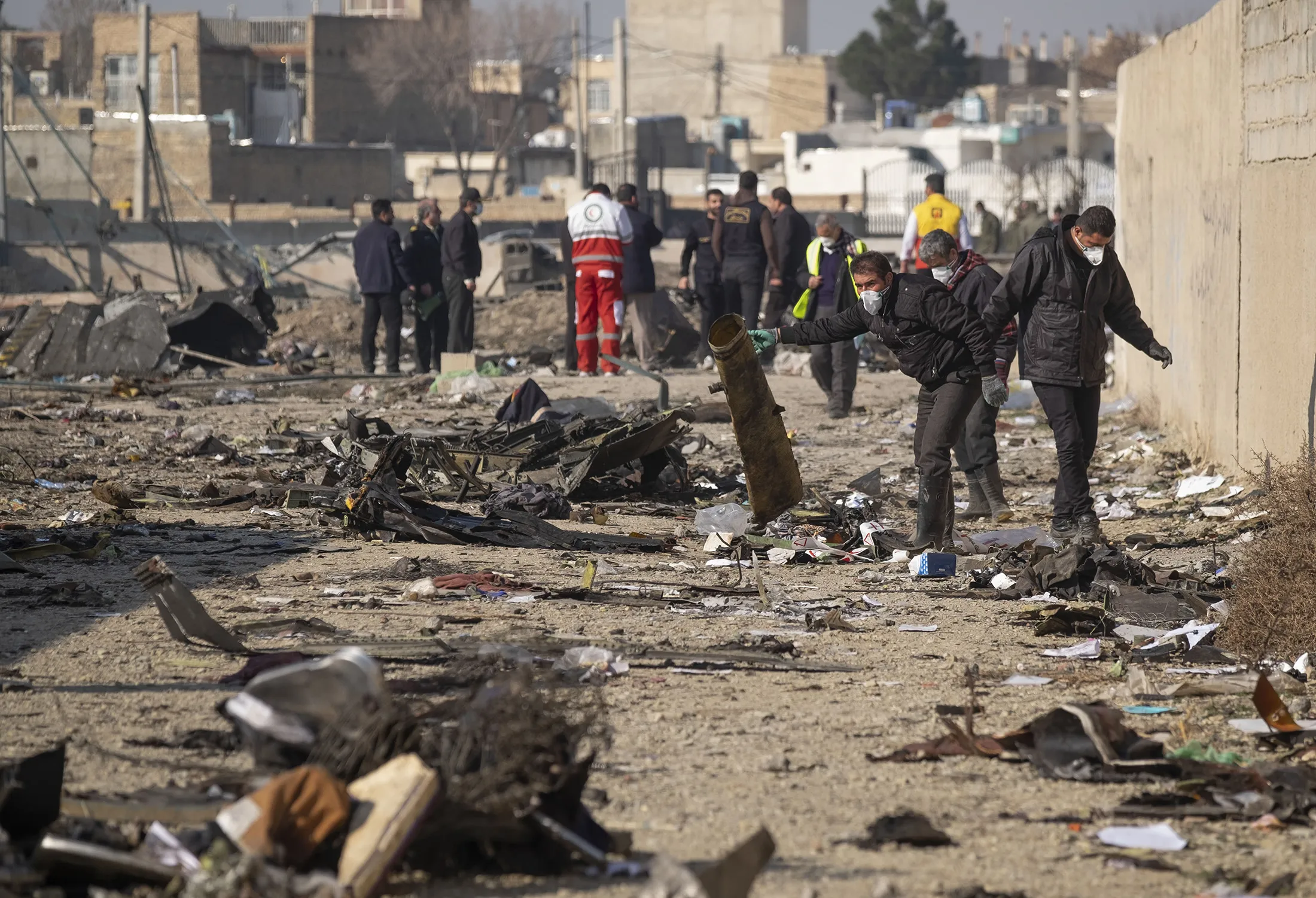 Officials work at the Ukrainian flight PS752 International airlines crash site, after the flight was shot down near&nbsp;Tehran, Iran, on Jan. 8, 2020.