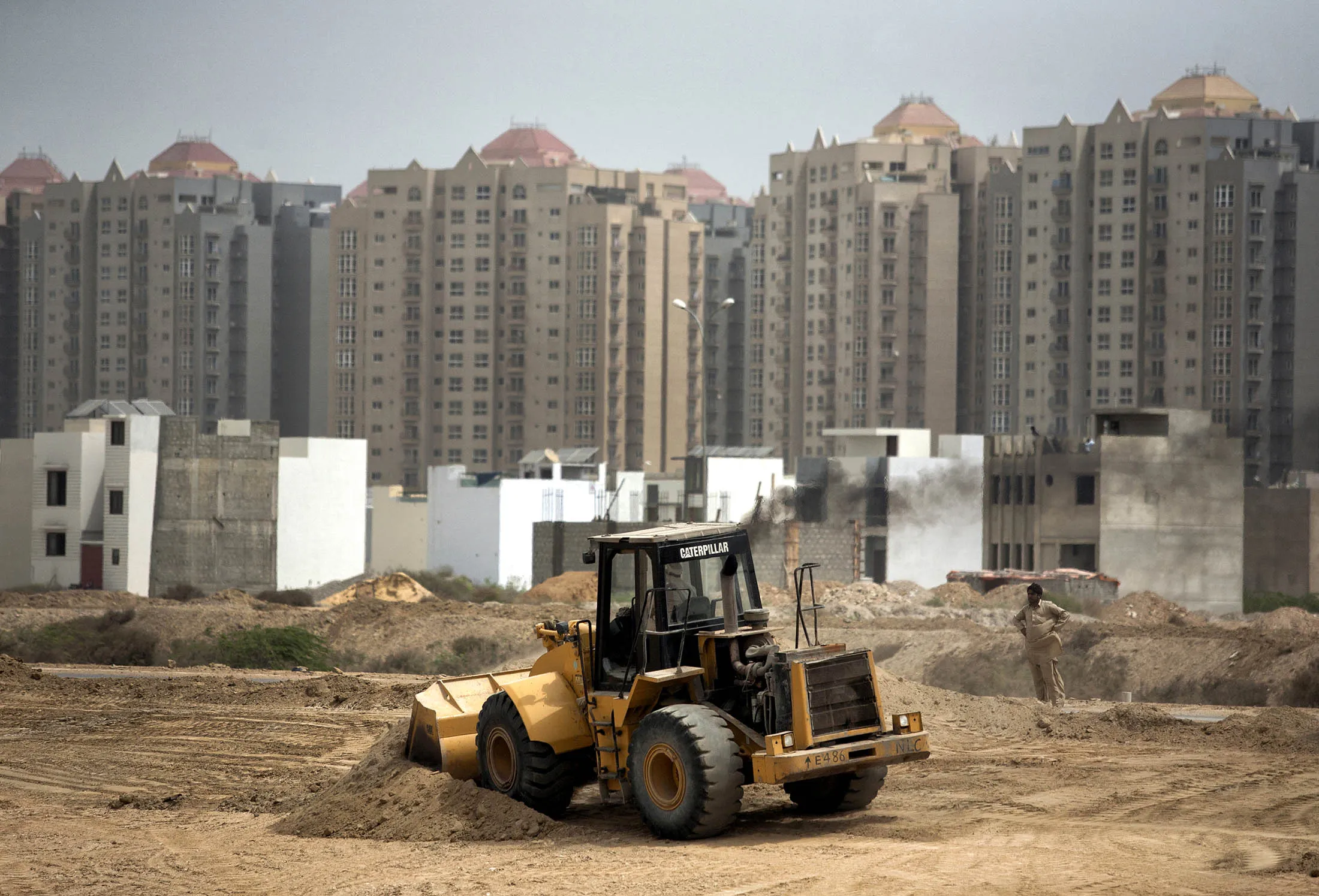 A digger operates at a construction site in Karachi, Pakistan. Land prices in the nation’s financial capital surge amid rising demand and an improving security situation.

