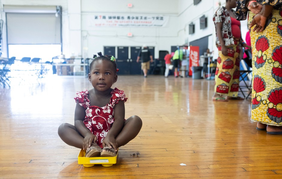 A young girl from the Democratic Republic of the Congo awaits resettlement in a gym in Portland, Maine, in 2019.