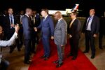 Emmanuel Macron is greeted by Benin Minister of Culture Jean-Michel Abimbola at Cotonou airport on July 27.