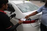 A gas station clerk gives a receipt to a customer in Dhaka, on Aug. 9. 