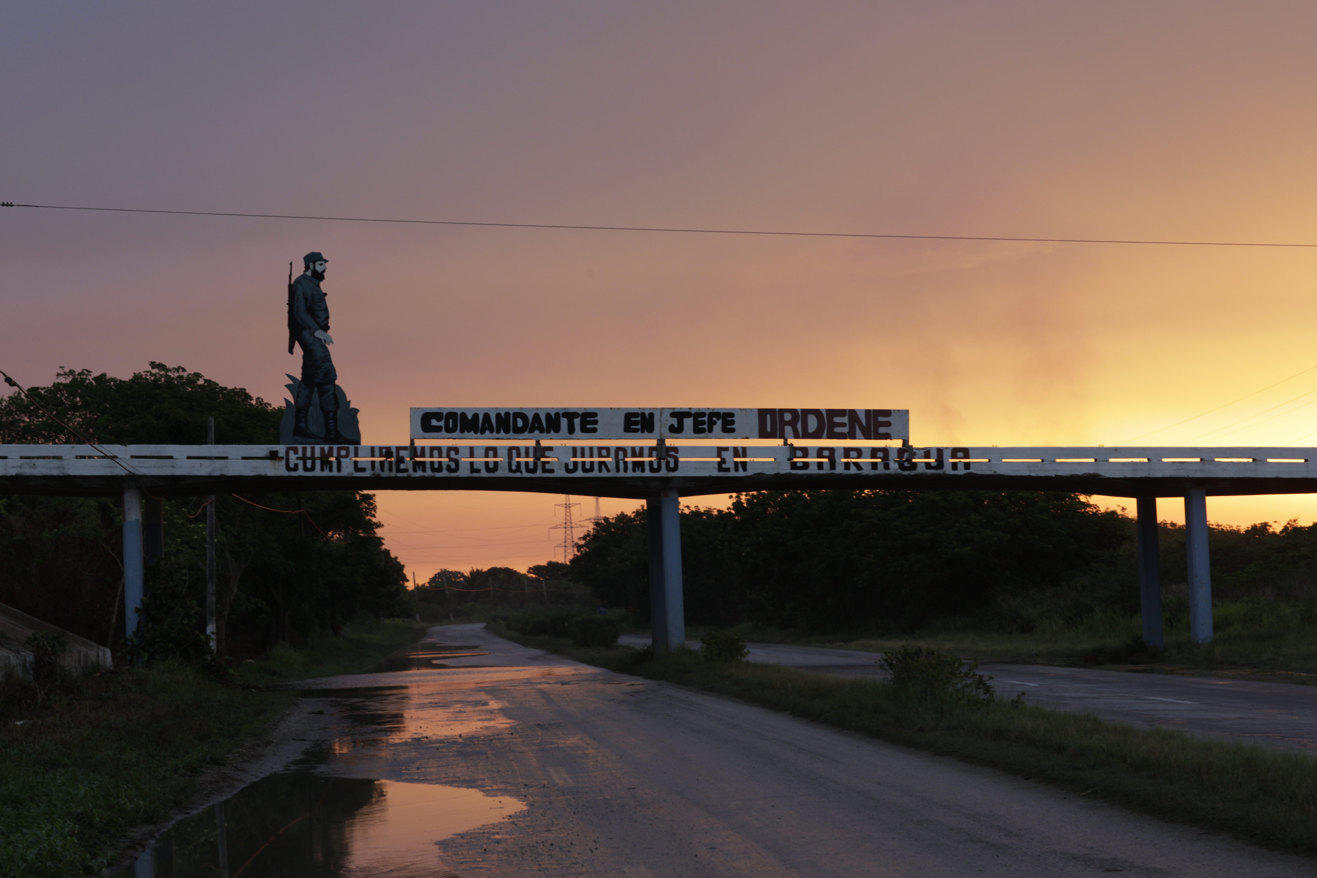 Propaganda outside Mariel, a new base for private investment. The sign reads, “By order of the commander in chief, we fulfill our promise at Baragua.” It refers to a 19th-century Cuban rebellion against colonial Spain.
