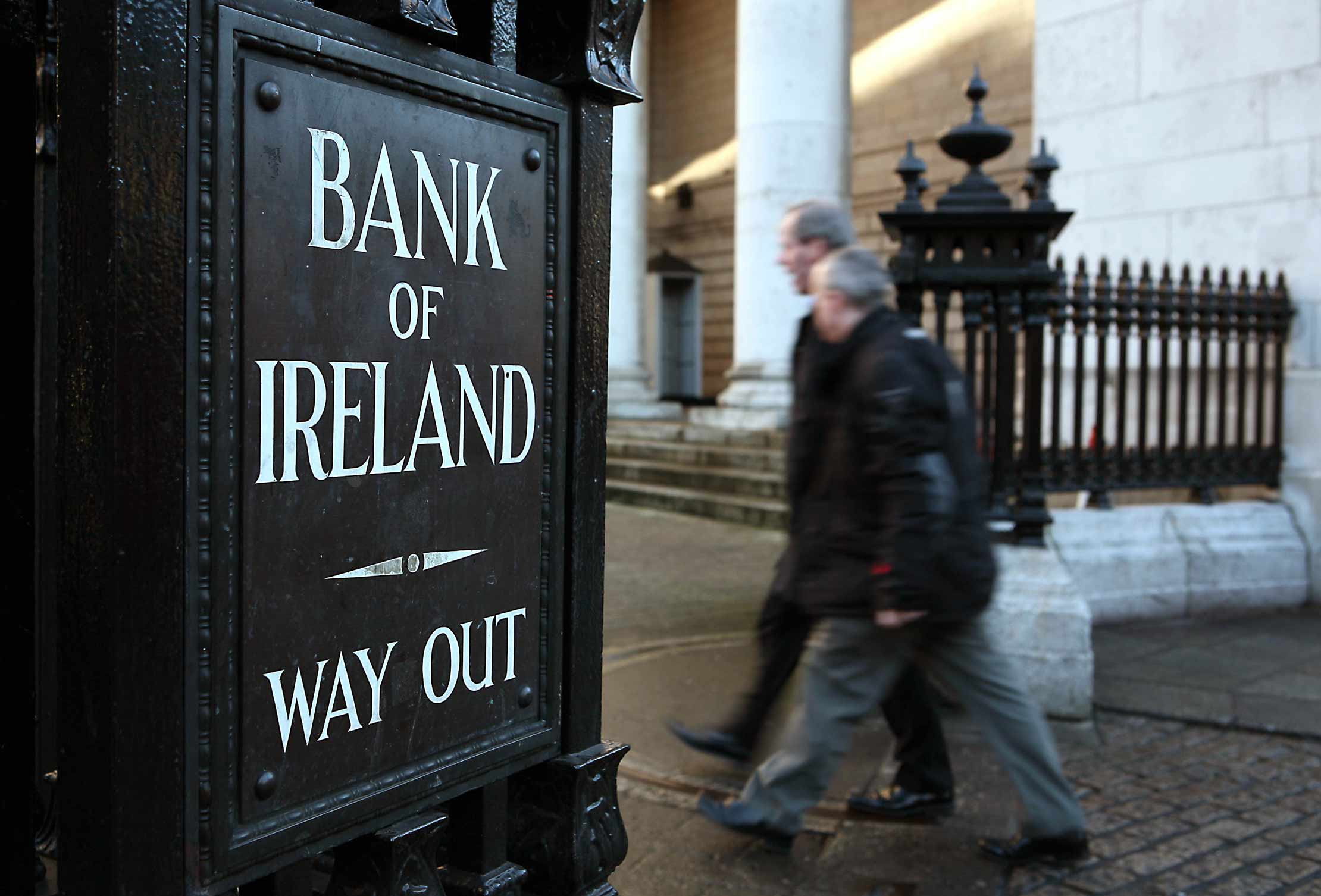 Pedestrians pass the Bank of Ireland offices in Dublin, Ireland.
