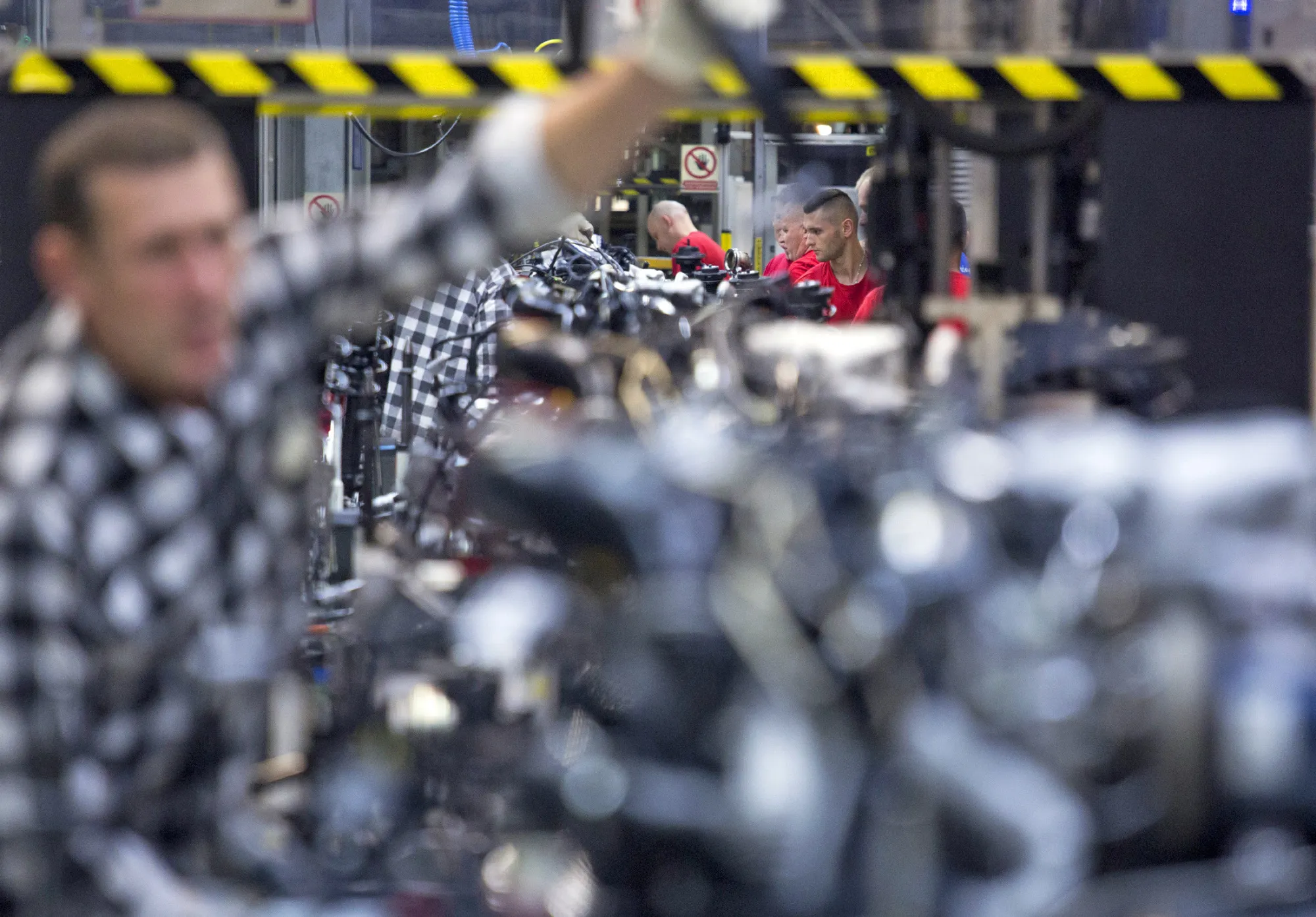 Workers prepare to fit new turbo diesel engines (TDI) to Volkswagen AG Caddy vans on the production line at the VW plant in Poznan, Poland, on Wednesday, Dec. 22, 2015. Volkswagen's struggles mark a stark contrast to a buoyant recovery in Europe's auto market.
